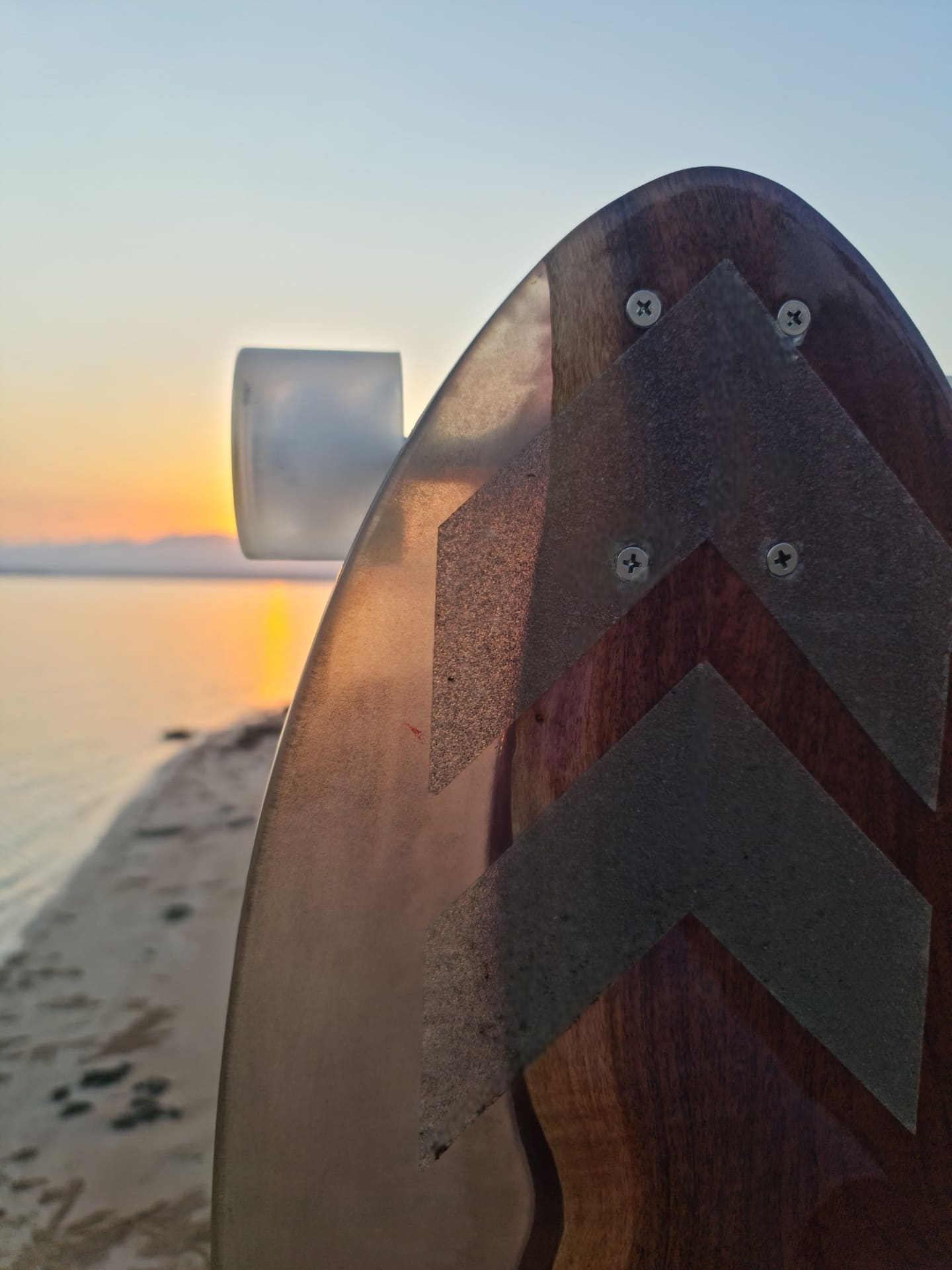 Close-up of chevron resin longboard tip at the beach during sunset