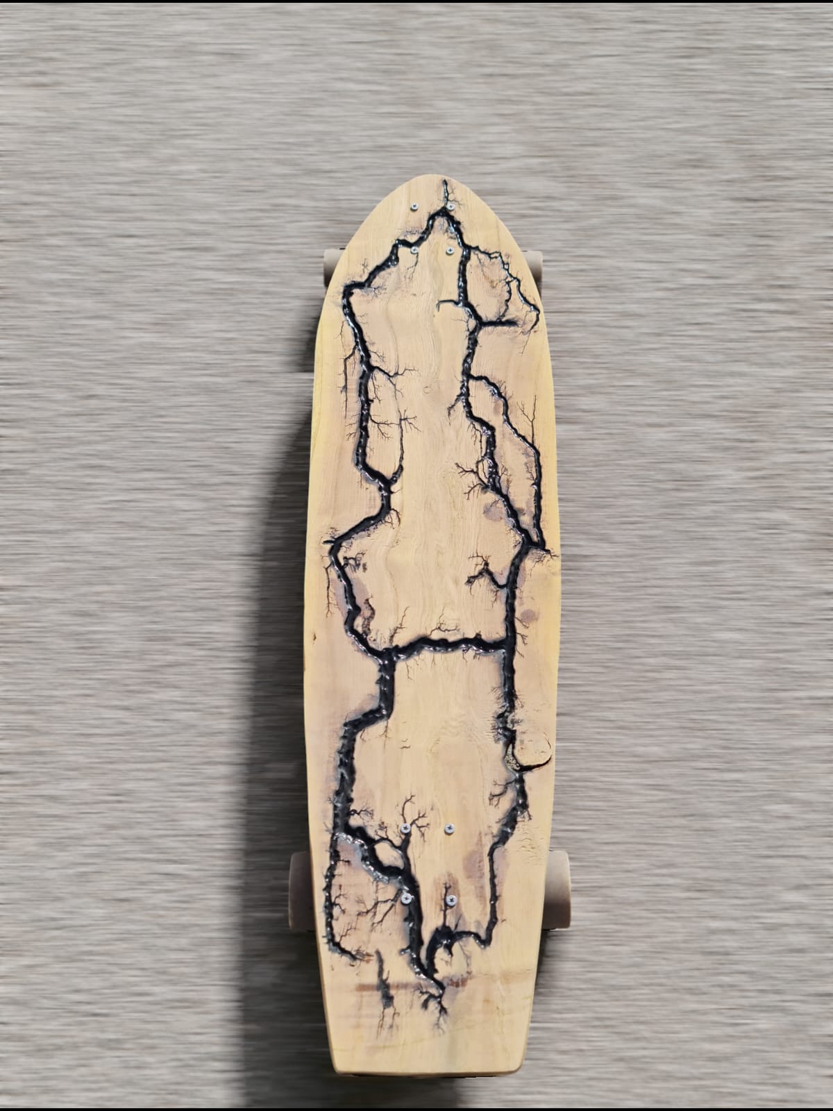Thunder Rift handmade longboard with black lightning resin channels in pale wood — view 1